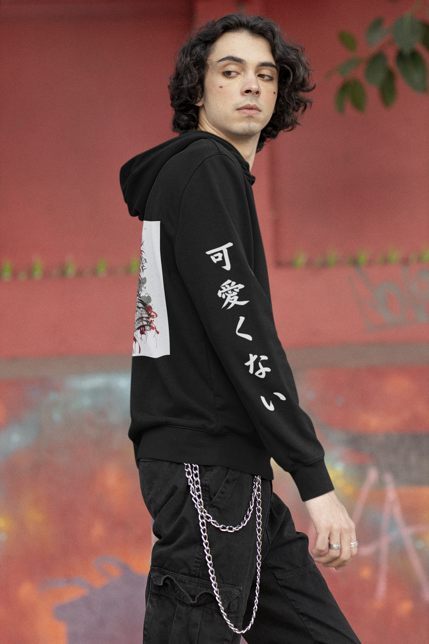 Model posing from the side in Kawaikunai black samurai hoodie with the Japanese writing of Kawaikuani in white down the sleeve
